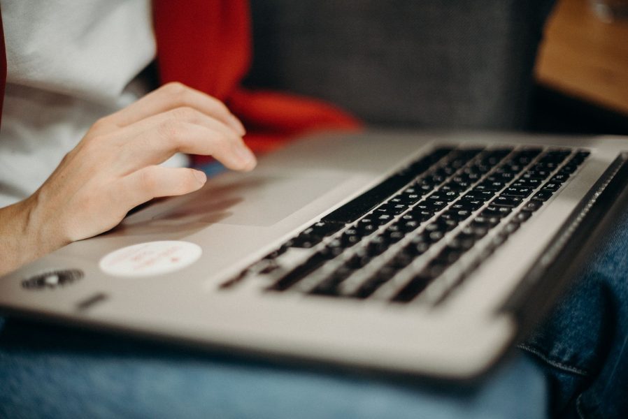 person using gray laptop computer